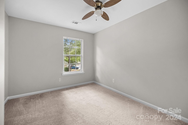 spare room with carpet and ceiling fan