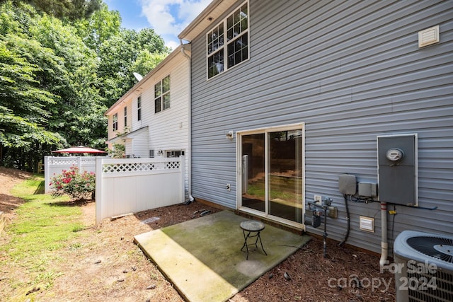 rear view of house featuring a patio and central AC unit