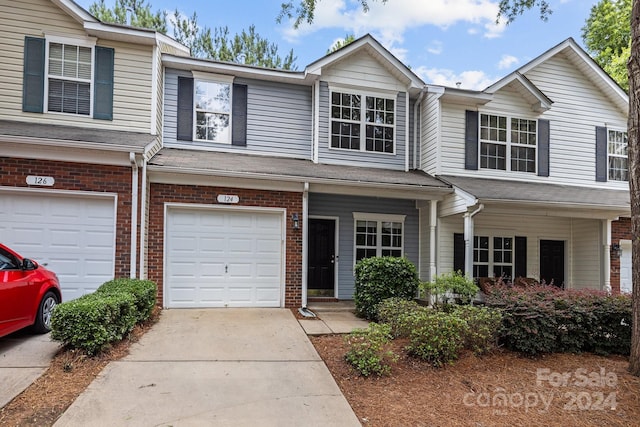 townhome / multi-family property featuring a garage