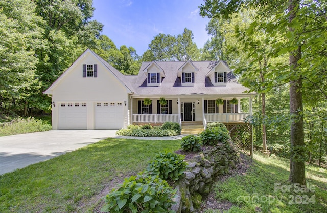 cape cod home with a garage, covered porch, and a front lawn