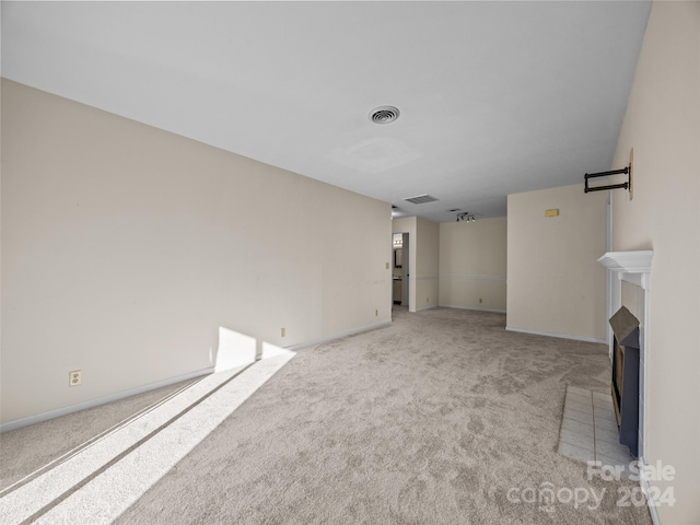 unfurnished living room with light colored carpet