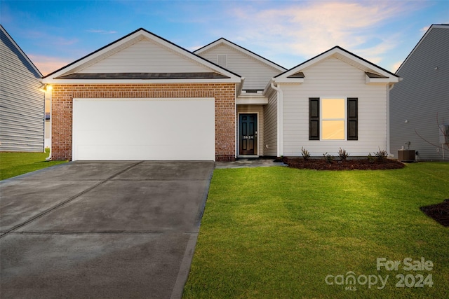 single story home with a garage, central air condition unit, and a lawn