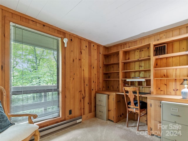 carpeted office featuring wooden walls, built in features, and baseboard heating