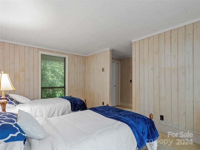 bedroom featuring carpet floors and wood walls