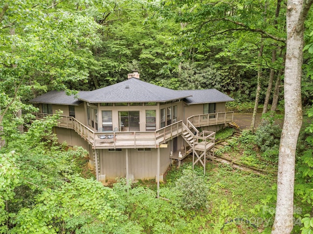 rear view of house featuring a wooden deck