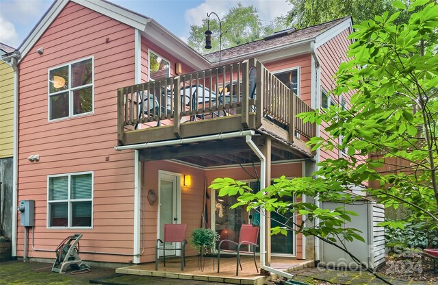 rear view of property with a balcony