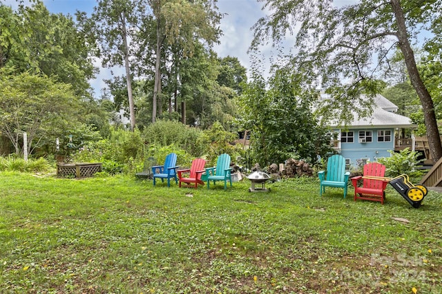 view of yard with an outdoor fire pit