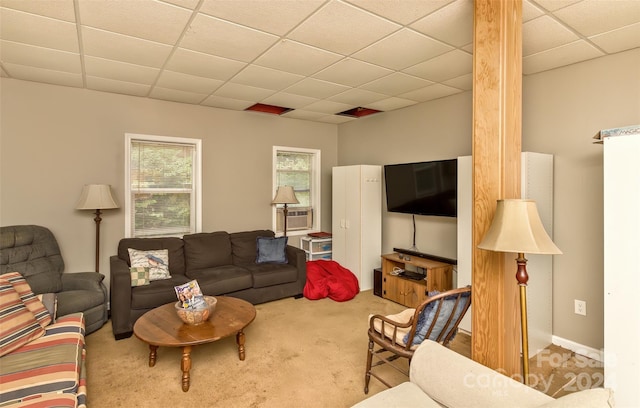 carpeted living room with a drop ceiling