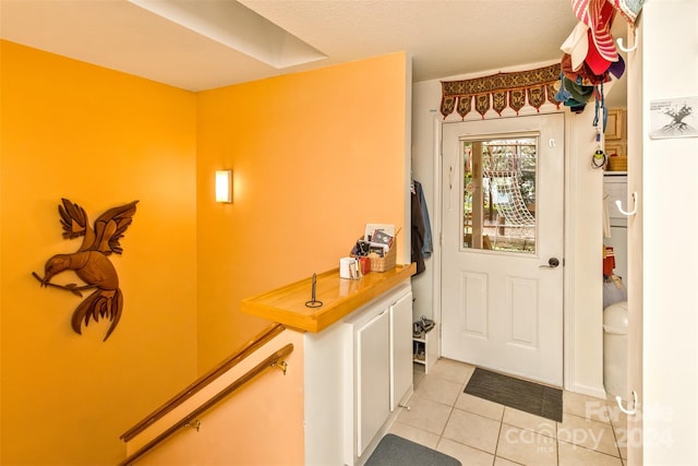 entryway with light tile patterned floors