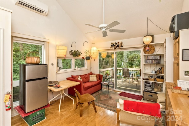 living room featuring a healthy amount of sunlight, a wall mounted air conditioner, light wood-type flooring, and ceiling fan