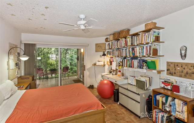 tiled bedroom with ceiling fan, access to outside, and a textured ceiling