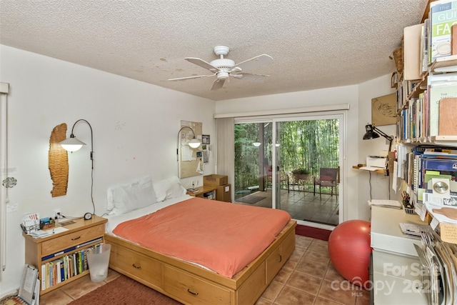 bedroom featuring a textured ceiling, access to outside, dark tile patterned flooring, and a ceiling fan