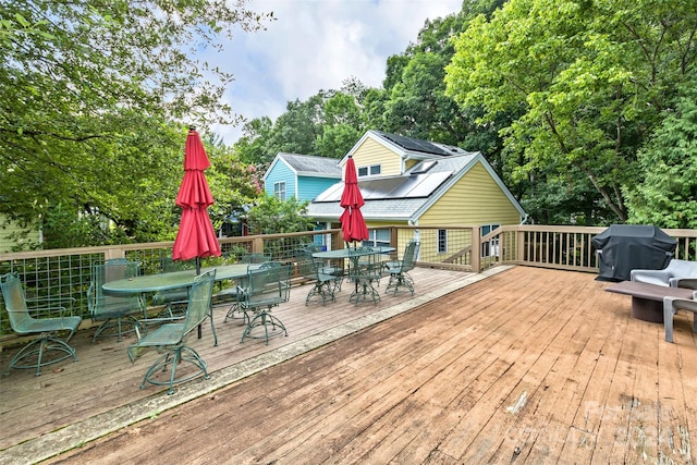 wooden terrace featuring area for grilling