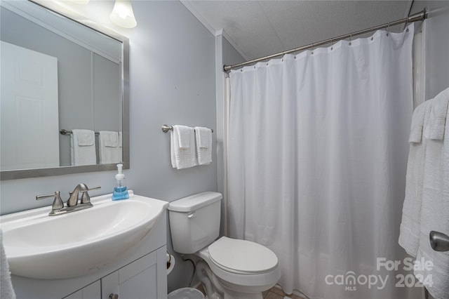 bathroom featuring a textured ceiling, vanity, a shower with curtain, toilet, and ornamental molding