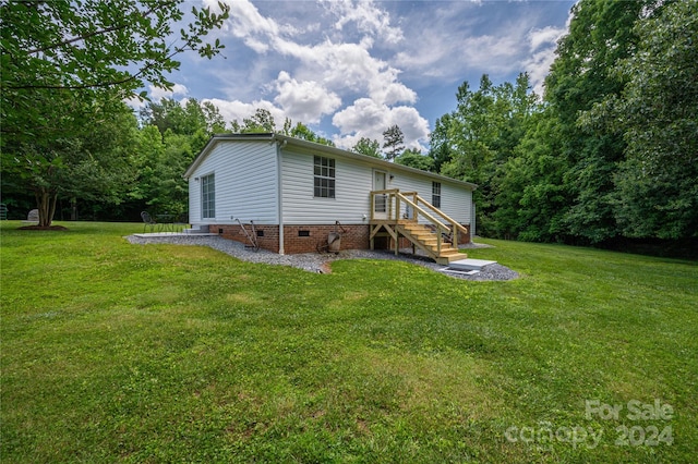 back of property featuring a lawn