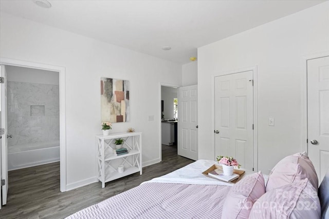 bedroom featuring dark hardwood / wood-style flooring and connected bathroom