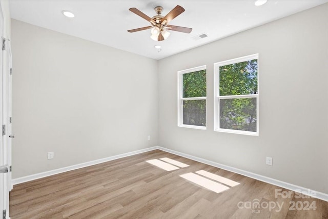 spare room featuring ceiling fan and light wood-type flooring