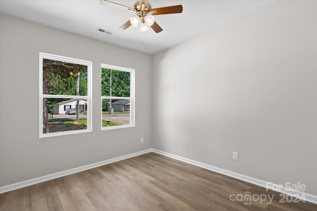 unfurnished room with hardwood / wood-style flooring and ceiling fan