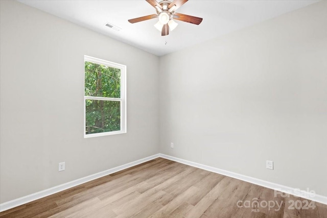 spare room with ceiling fan and light wood-type flooring