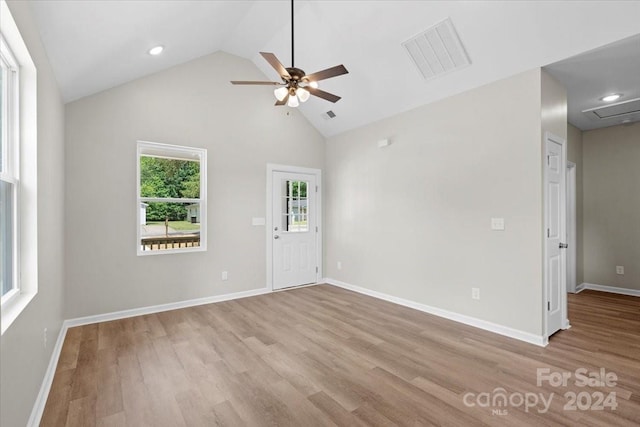 spare room with ceiling fan, high vaulted ceiling, and light hardwood / wood-style floors