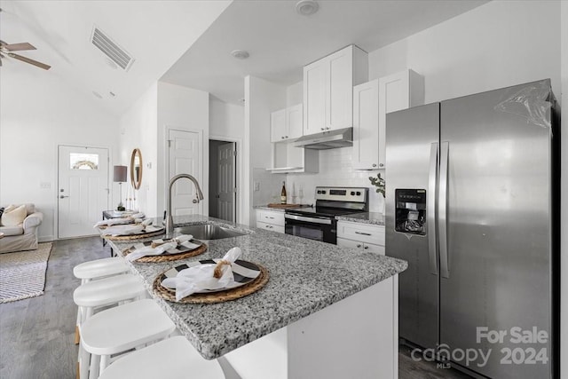 kitchen with sink, light stone countertops, an island with sink, dark hardwood / wood-style flooring, and stainless steel appliances