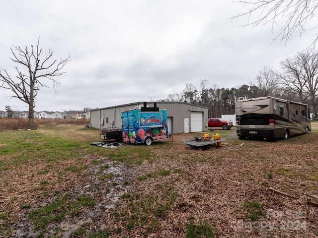 exterior space with a garage and an outdoor structure