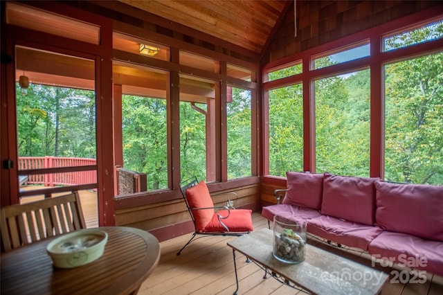 sunroom with lofted ceiling and a healthy amount of sunlight