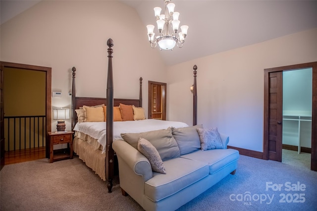 bedroom featuring light carpet, a spacious closet, vaulted ceiling, and a notable chandelier