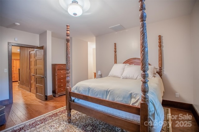 bedroom with hardwood / wood-style floors