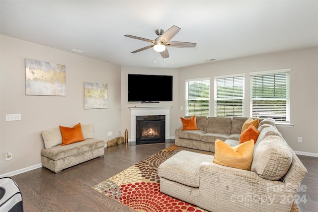 living room with ceiling fan and dark hardwood / wood-style flooring