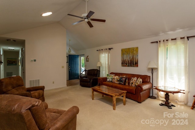 living room featuring ceiling fan, light colored carpet, and lofted ceiling