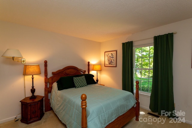 carpeted bedroom featuring a textured ceiling