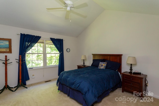 carpeted bedroom with vaulted ceiling and ceiling fan