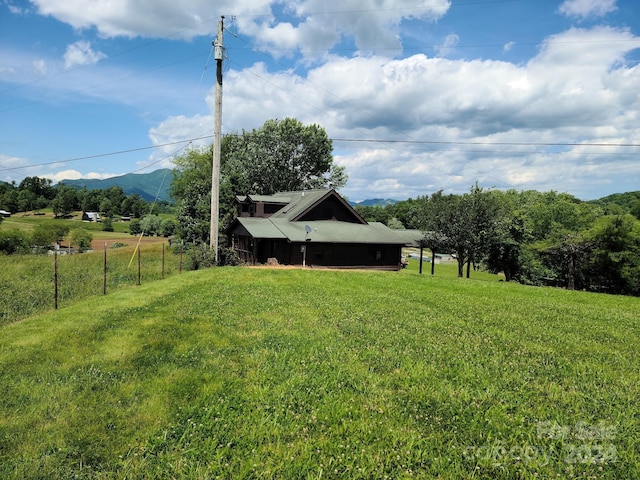 view of yard featuring a rural view and a mountain view