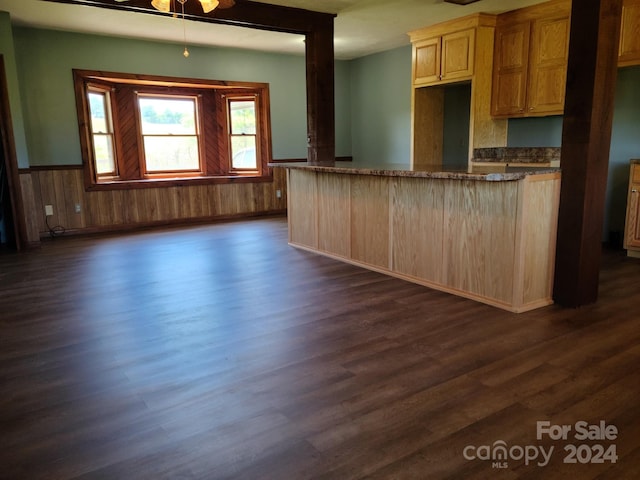 kitchen with kitchen peninsula, dark hardwood / wood-style flooring, and light brown cabinets