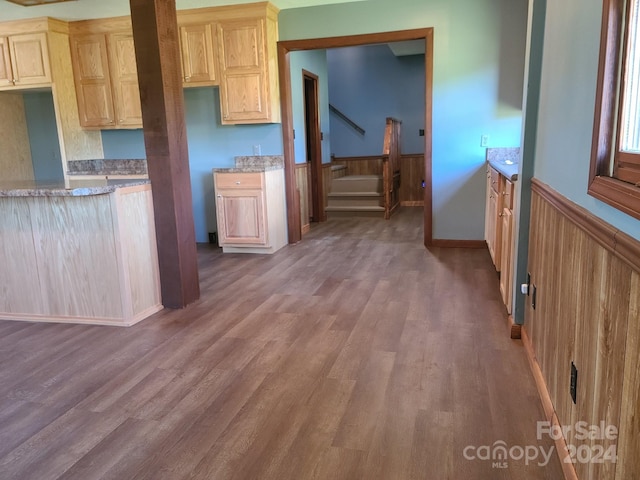 kitchen featuring light brown cabinetry and hardwood / wood-style floors