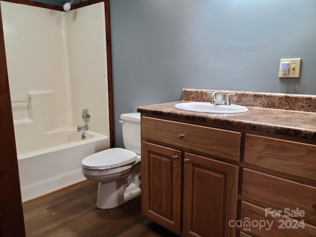 full bathroom featuring toilet, hardwood / wood-style floors, vanity, and shower / bathing tub combination