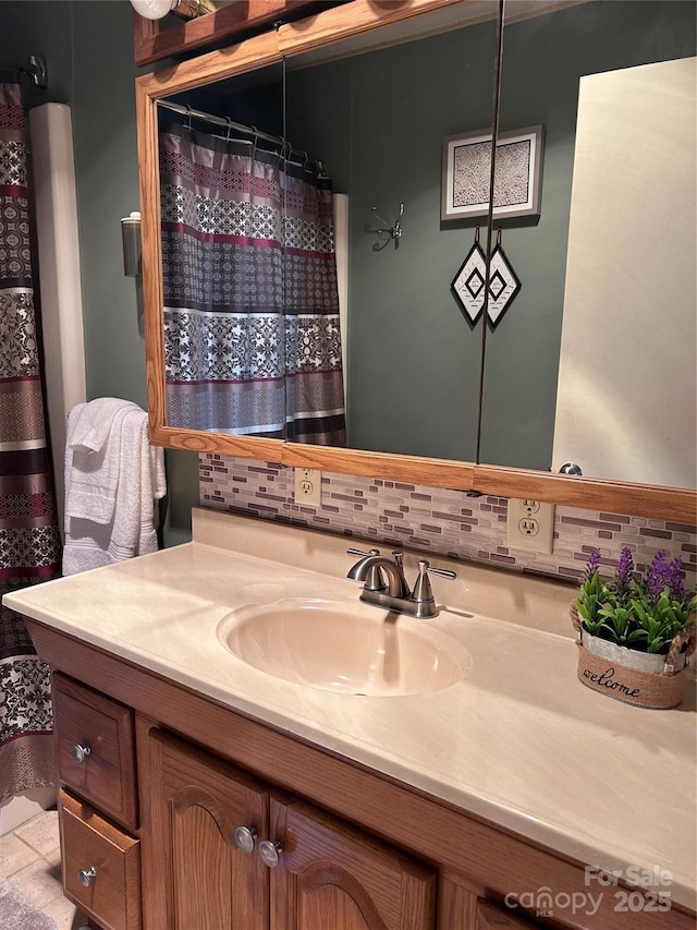 bathroom featuring vanity and tasteful backsplash