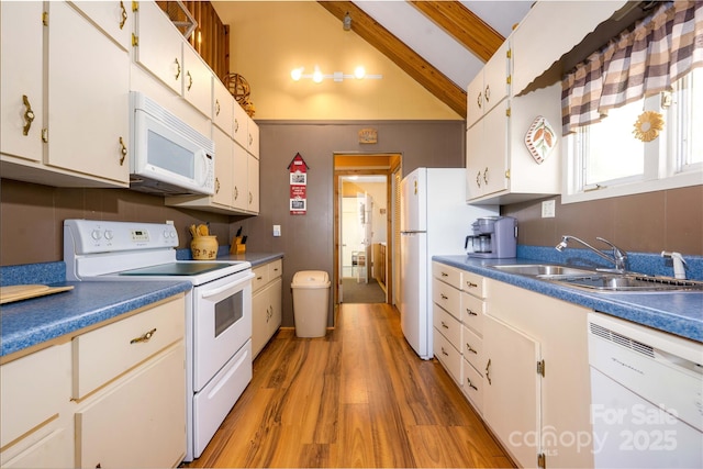 kitchen with sink, vaulted ceiling with beams, white appliances, white cabinets, and hardwood / wood-style flooring