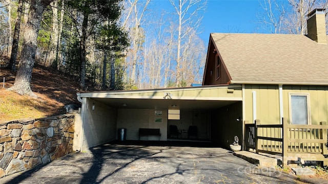 back of property featuring a carport