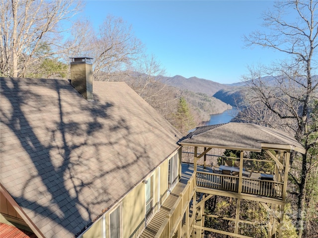 deck with a water and mountain view