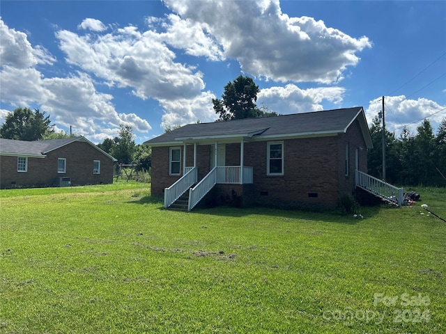 rear view of property with a yard