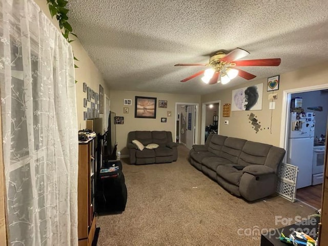 carpeted living room featuring ceiling fan and a textured ceiling