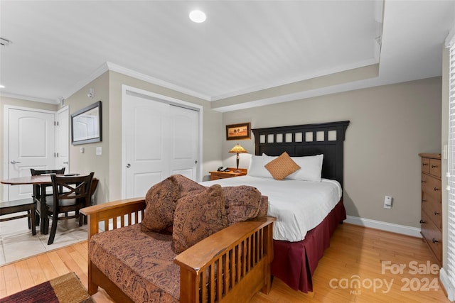 bedroom featuring crown molding, a closet, and wood-type flooring