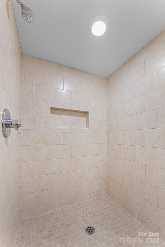 bathroom with tiled shower