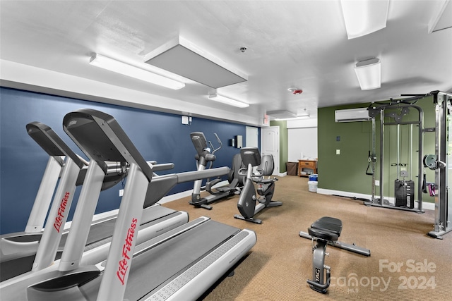 gym featuring an AC wall unit and carpet flooring