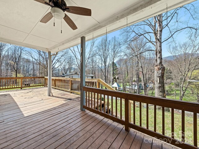 deck featuring a playground and ceiling fan