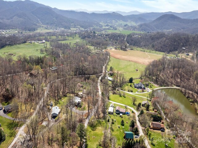 drone / aerial view featuring a water and mountain view