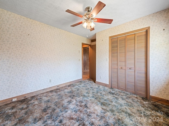 unfurnished bedroom with ceiling fan, a closet, carpet flooring, and a textured ceiling