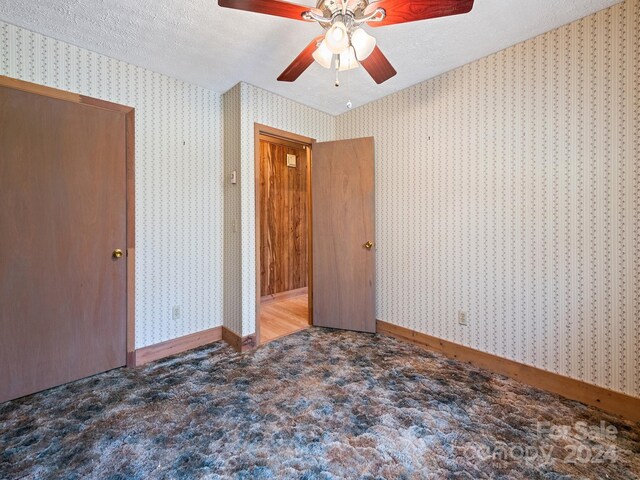 unfurnished bedroom with ceiling fan, a textured ceiling, and hardwood / wood-style flooring